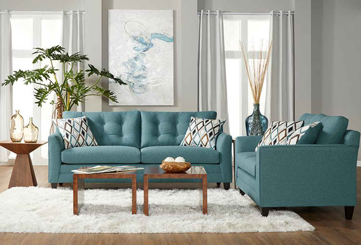 grey couch with teal pillows